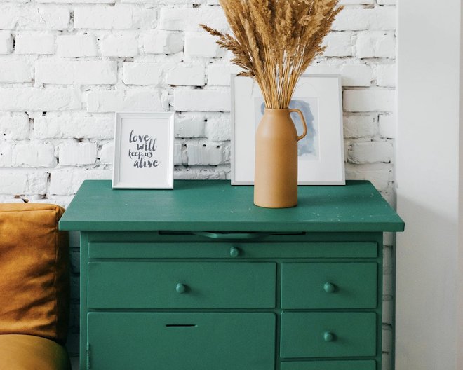 pic of green dresser with drawers and a sign that says love will keep us alive